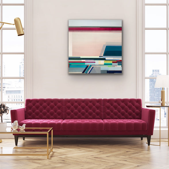 Modern living room with a red sofa and abstract art on the wall.